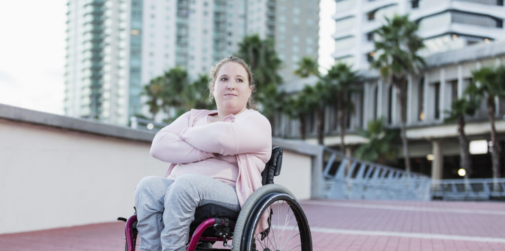Young woman with spina bifida in wheelchair
